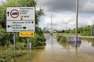 Floods: Flooding - cars partly submerged on flooded road in Newtown