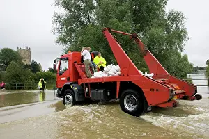 Lorry: Flooding - Lorry carrying sand bags driving along