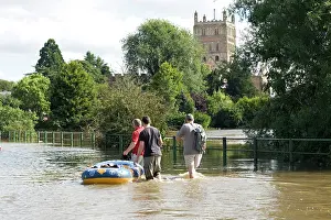 Opposite: Flooding - People with rubber dingy carrying bottled