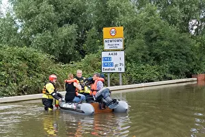 Rescues: Flooding - Rescue team with people in inflatable