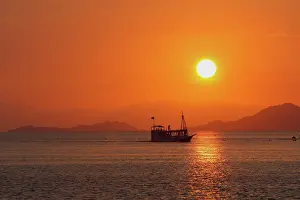 Ferries: Flores Island - showing boat transport to island at sunset