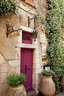 Cote: Flowering vine surrounds the front door