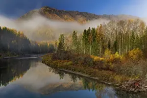 Montana: Foggy autumn sunrise light on McDonald Creek and Apgar