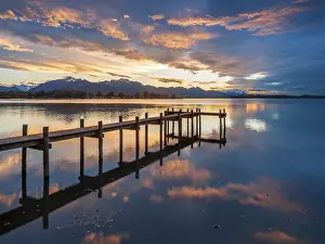 Walkway: Footbridge on Lake Chiemsee at sunset, with the Chiemgau