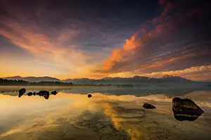 Bergen: Forggensee with reflection of the cloudy sky and