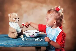 Child: Four-year old girl feeding teddy bear, Austria