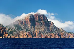 Butt: France, Corsica. Clouds blow over Cape Rossu