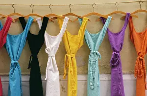 Dresses: FRANCE - Multi coloured dresses hanging in a row