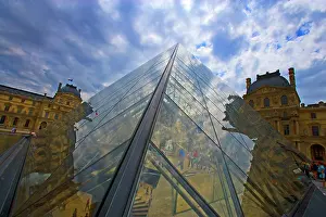 Paris: France, Paris. Clouds reflect off the Louvre