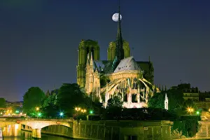 Worship: France, Paris. Full moon over Notre Dame