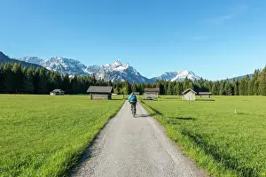 Bicycle: Frau radelt, hay barns in a meadow, Ehrwalder Sonnenspitz