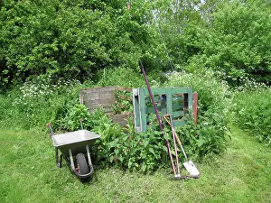 Compost: Garden compost area with wheelbarrow and tools