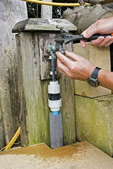 Repairing: Garden Tap - person repairing brass leaking tap