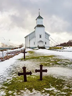 Lofoten: Gimscy church with cemetery, snow-covered mountains