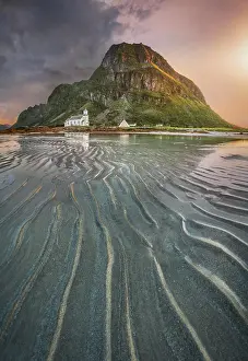 Overgrown: Gimsoy church in front of a sandy beach with ribbed