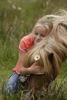 Cuddle: Girl caressing her Pony Netherlands