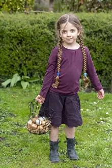 Gallus: Girl carrying a basket full of chicken eggs in a
