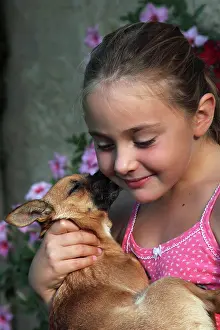 Sized: Girl carrying a Chihuahua - France