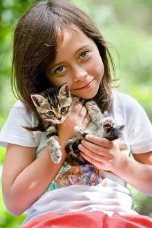 Arms: Girl carrying a kitten in the arms Alsace France