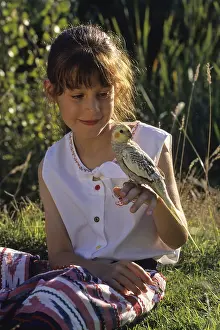 Aestival: Girl with Cockatiel elegant on the finger