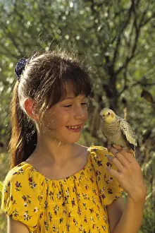 Aestival: Girl with Cockatiel elegant on the finger