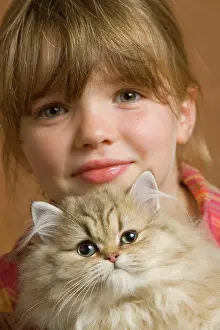 Holdiing: Girl - cuddling Persian Kitten