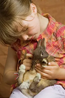 Holdiing: Girl - cuddling rabbit