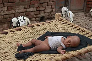 Poverty: Girl doing a nap in an street Inde
