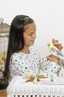 Nymphicus: Girl Having Tea Party with Her Cockatiel
