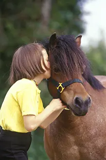 Kisses: Girl kissing her pony