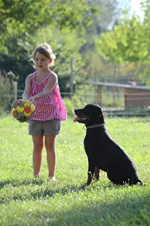 Collusions: Girl playing with a dog - France