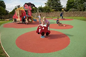 Playgrounds: Girl playing with safety rubber activity matting