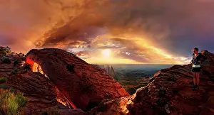 Canyonlands: Girl at sunrise at the stone arch Mesa Arch, Canyonlands