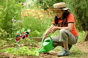 Allotment: Girl - watering garden with watering can