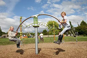Playground: Two girls enjoying hi-tech seesaw at new playground