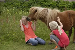 Enjoy: Girls playing with their pony Frisia Netherlands