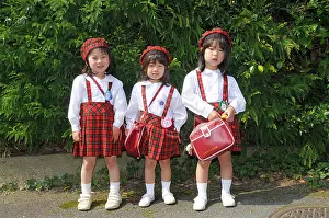 Rearing: Three girls in the uniform of an elite nursery school