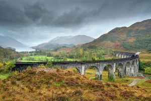 Viaduct: Glenfinnan Viaduct with steam locomotive in autumn