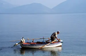Fisherman: GREECE - Fisherman searching the shallows for fish