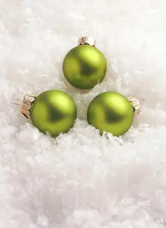 Sign: Three green Christmas baubles in the snow, Christmas