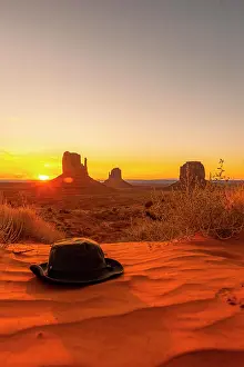 Table: A green hat on the red sand at dawn in Monument