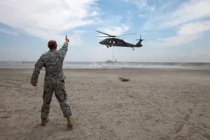Helicopter: Guardsman Directs Placement of Sandbags