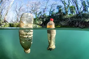 Scrap: Half-air, half-water view of plastic bottles floating