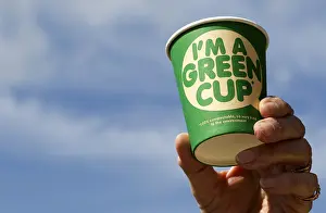 Paper: Hand holding 100% compostable Green recyclable coffee