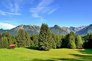 Surrounded: Haystack on a mountain meadow, surrounded by mountain