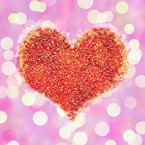 Glitter: Heart on glowing light background with glitter and bokeh