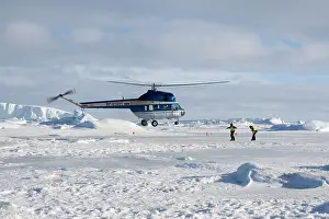Helicopter: Helicopter from cruise ship landing on sea ice Weddle sea