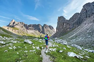 Mountaineer: Hiker, mountaineer on a trail between rocky mountains