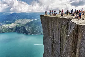 Platform: Hiker on rocky peak Preikestolen, view of Lysefjord