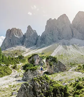 Hiker: Hiker standing on rocks, scree field below the Geisler
